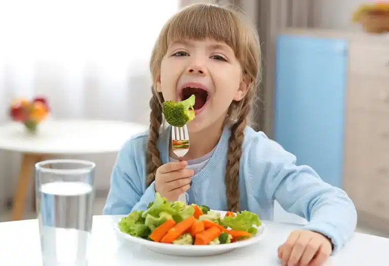 An image depicting Great Tips For Children To Eat Salads, including benefits of eating salads , onion bulbs, broccoli florets, and cabbage leaves.